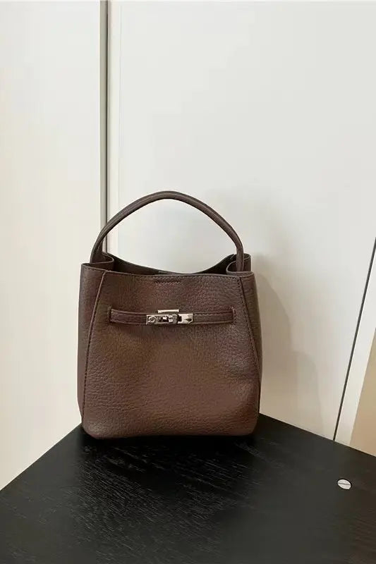 An image of a   TF0085 Vegan Leather Belted Lock Handbag by  Mirra Masa