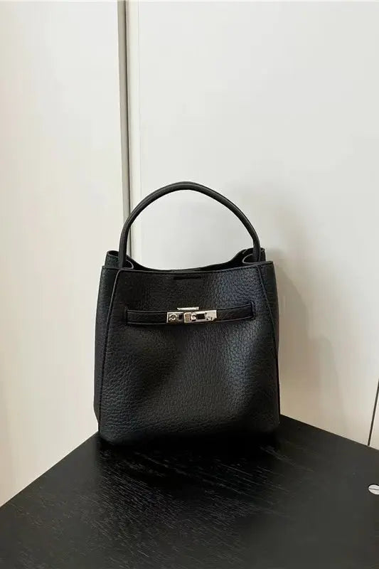 An image of a   TF0085 Vegan Leather Belted Lock Handbag by  Mirra Masa
