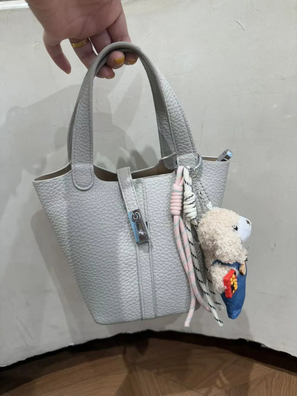 An image of a   TF0096 Lock Detail Bucket Bag by  Mirra Masa