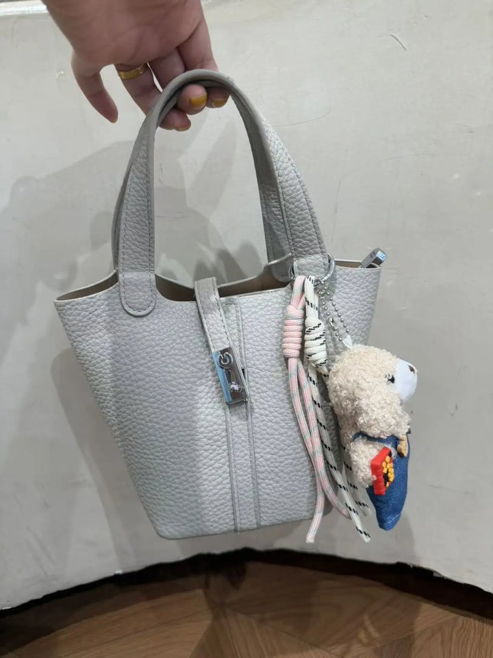 An image of a   TF0096 Lock Detail Bucket Bag by  Mirra Masa