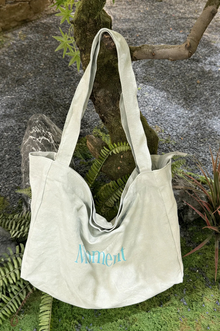 An image of a   TF1203 Graphic Text Tote Bag by  Mirra Masa