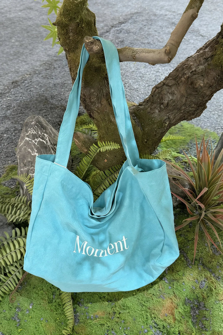 An image of a   TF1203 Graphic Text Tote Bag by  Mirra Masa