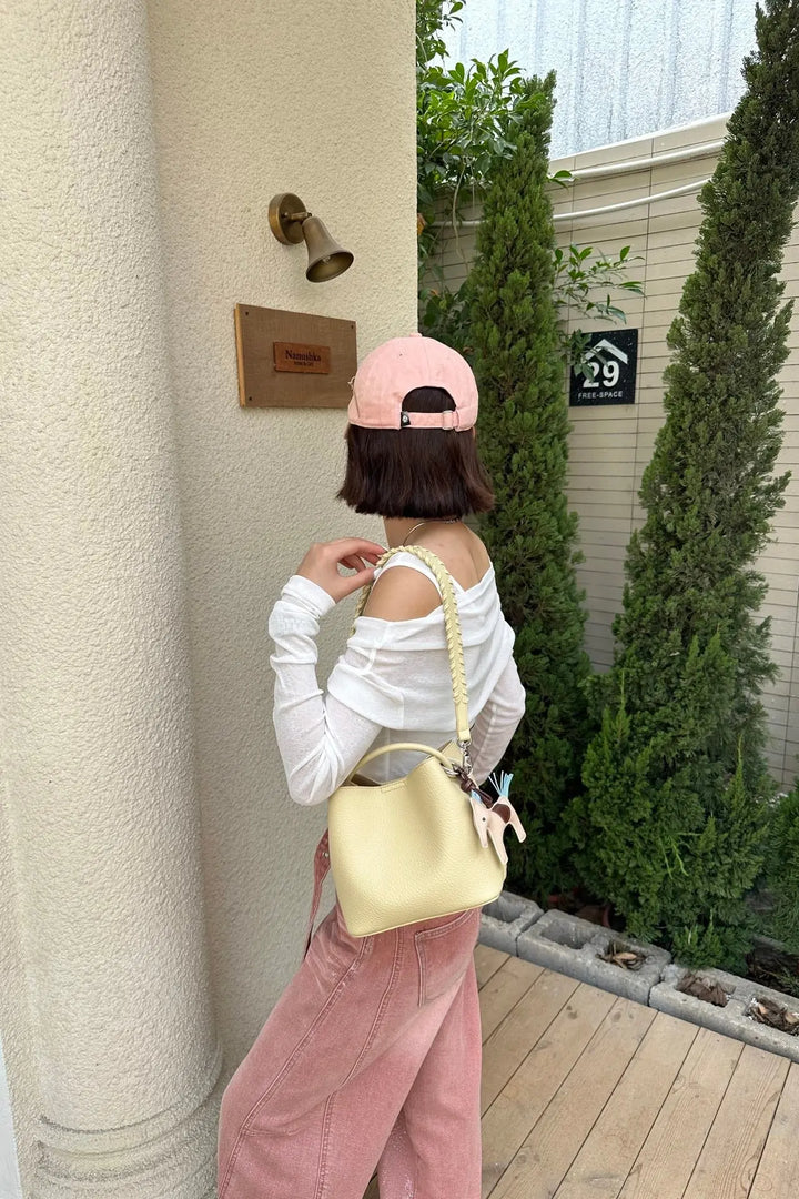 An image of a   TF2561 Braided-Strap Bucket Bag by  Mirra Masa