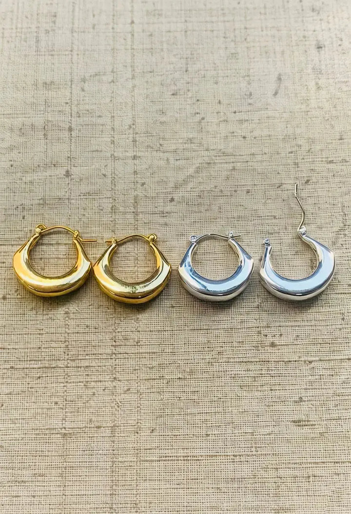 An image of a   Tapered Crescent Hoop Earrings by  Mirra Masa