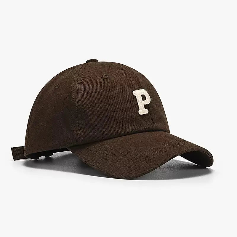 An image of a  Brown Terry P Letter Baseball Cap by  Mirra Masa