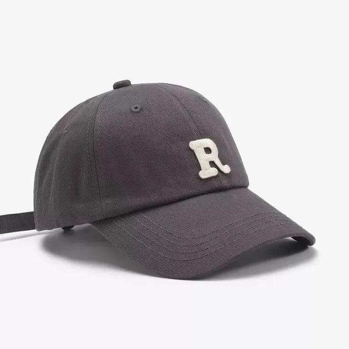 An image of a  Grey Terry R Letter Baseball Cap by  Mirra Masa